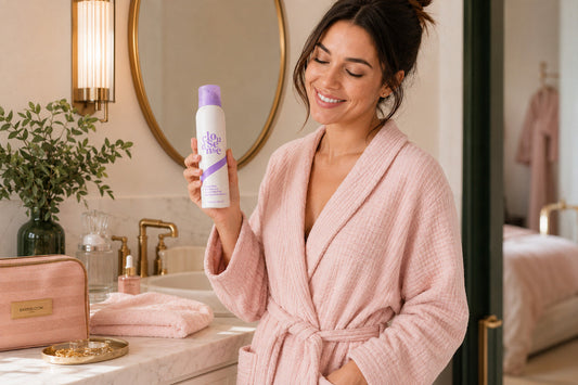 BareBloom bikini hair removal cream beside a towel in a refined bathroom before an at-home body-care routine