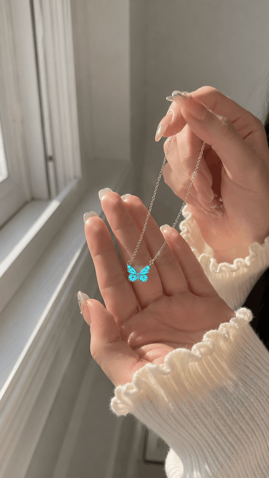 AuraWing luminous butterfly necklace glowing in soft daylight